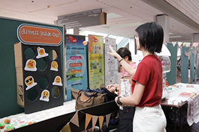 A student playing a game at a booth